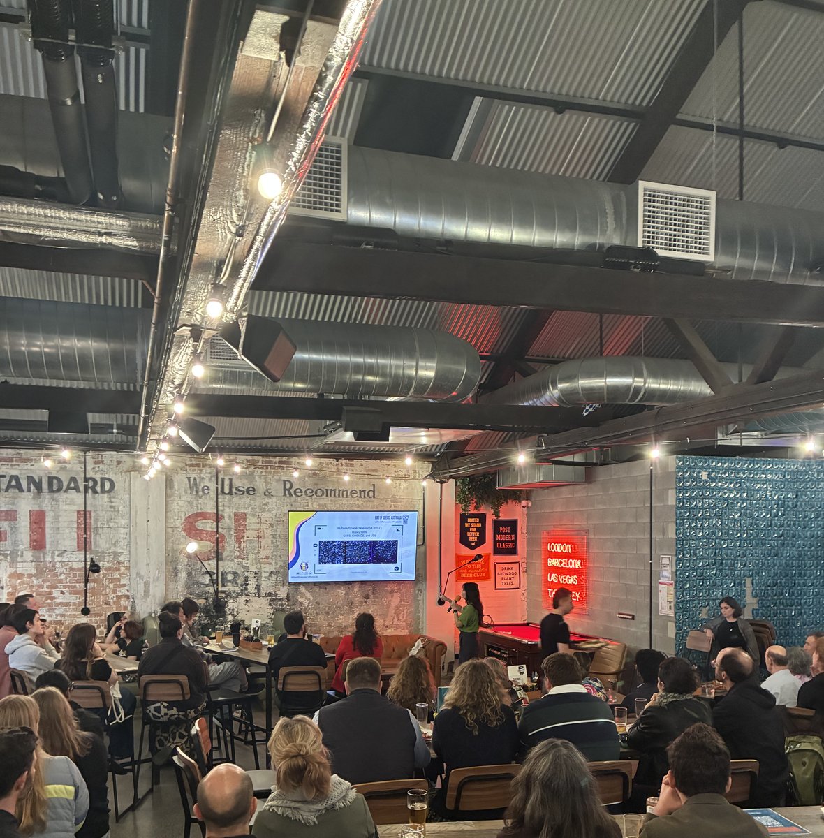 Wide view of Vanessa Porchet presenting to a full audience at BrewDog